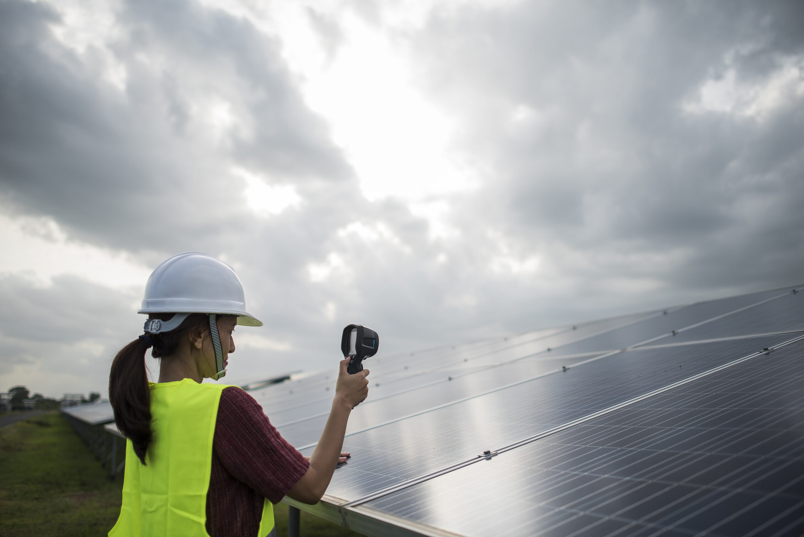 Engineer electric woman checking and maintenance of panasonic solar panel.