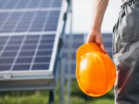 man-worker-firld-by-solar-panels-1